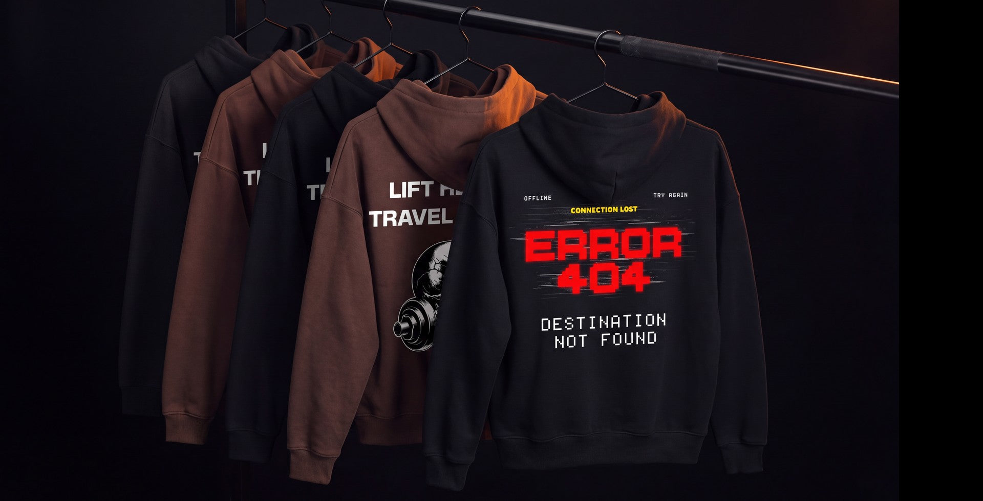The Error 404 and Lift Heavy Travel Light hoodies hanging back to camera on a rail