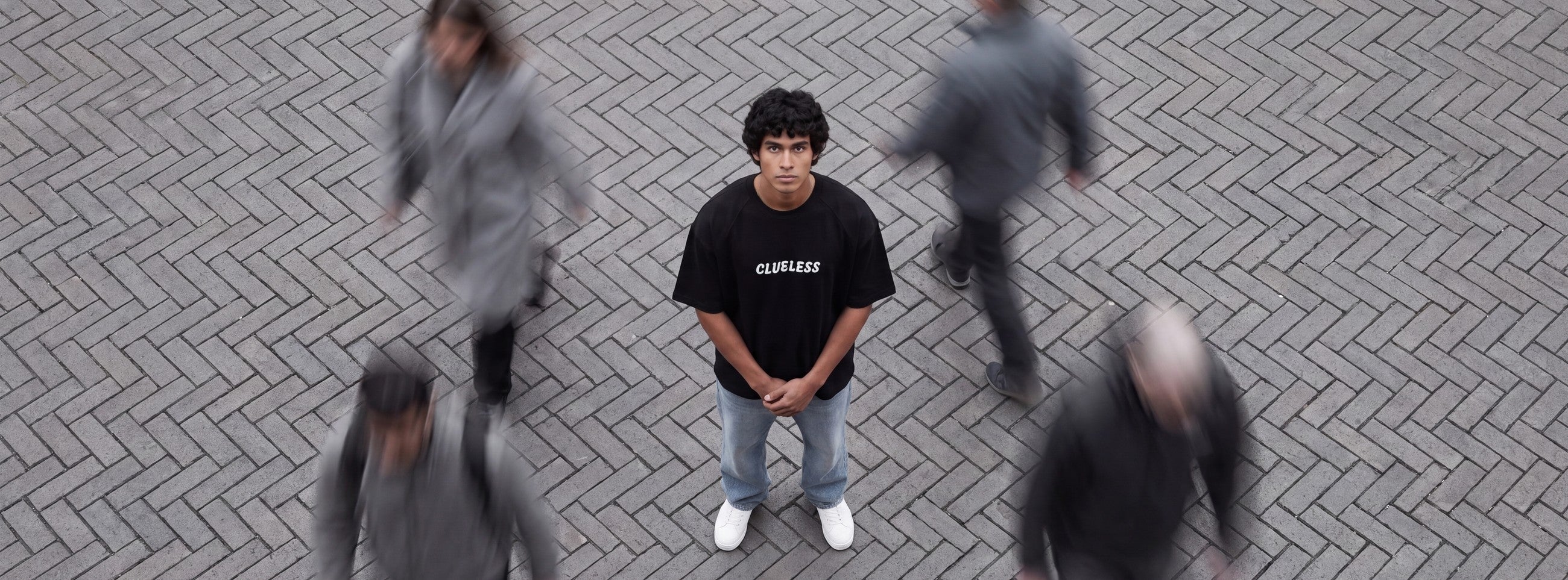 Tokyo City oversized tee, seen from above on a brick pavement
